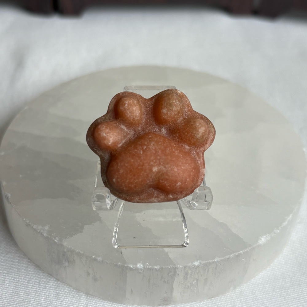 Orange calcite crystal paw carving